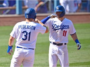 Sep 27, 2020; Los Angeles, California, USA;  Los Angeles Dodgers left fielder A.J. Pollock (11) is greeted by Los Angeles Dodgers right fielder Joc Pederson (31) after hitting a two run home run in the seventh inning of the game against the Los Angeles Angels at Dodger Stadium. Mandatory Credit: Jayne Kamin-Oncea-USA TODAY Sports ORG XMIT: USATSI-429191