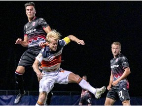 Cavalry FC’s Dominick Zator (left) and Forge FC’s Kyle Bekker collide while competing for a ball on Aug. 13, 2020 during the opening game of the Canadian Premier League’s Island Games in Charlottetown, P.E.I. The match ended in a 2-2 draw. Canadian Premier League/Chant Photography