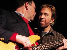 Chuck Norris, right, is pictured with then Republican presidential hopeful and former Arkansas Governor Mike Huckabee during a "Huck and Chuck" rally at the Val Air Ballroom in Des Moines, Iowa, Jan. 1, 2008.