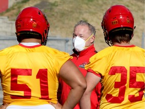 Paul Carson, Offensive Line Coach, works with players as the University of Calgary Dinos football team returns to the turf at McMahon Stadium. The Dino's have a practice-only schedule for 2020 after Canada West cancelled all fall sports due to the COVID-19 pandemic. Tuesday, September 8, 2020. Brendan Miller/Postmedia