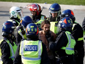 A man is detained during a demonstration in Trafalgar Square against the lockdown imposed by the government in London, September 19, 2020.