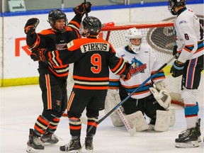 Lloydminster Inland Steel Bobcats Caden Cabana celebrates with teammate Jagger Firkus after scoring on Bailey Monteith of the Okanagan Rockets during Macs AAA Hockey Tournament in Calgary on Monday December 30, 2019. Al Charest / Postmedia