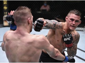 Dustin Poirier punches Dan Hooker of New Zealand during UFC Fight Night at the UFC APEX.