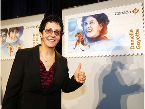 Olympic Womens Hockey, Danielle Goyette checks out her stamp as Canada Post unveiled five stamps to honour six barrier breaking role models at Canada's Sports Hall of Fame in Calgary, Alta., on Wednesday, January 24, 2018. Darren Makowichuk/Postmedia
