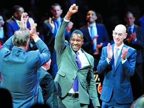 Toronto Raptors president Masai Ujiri celebrates getting his championship ring as NBA commissioner Adam Silver looks on before a game at Scotiabank Arena.