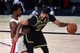 L.A. Lakers' Anthony Davis is defended by Miami Heat forward Jimmy Butler.