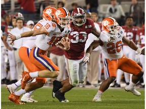 SANTA CLARA, CA - JANUARY 07:  Trevor Lawrence #16 of the Clemson Tigers carries the ball against the Alabama Crimson Tide in the CFP National Championship presented by AT&T at Levi's Stadium on January 7, 2019 in Santa Clara, California.