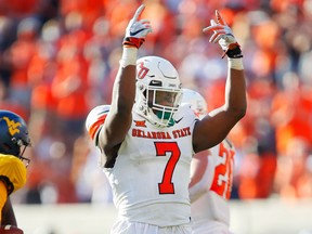 Linebacker Amen Ogbongbemiga of the Oklahoma State Cowboys celebrates after sacking quarterback Jarret Doege of the West Virginia Mountaineers on Sept. 26, 2020 at Boone Pickens Stadium in Stillwater, Okla. Brian Bahr/ Getty Images