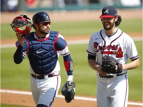 ATLANTA, GA - OCTOBER 01: Ian Anderson #48 has a laugh with Travis d'Arnaud #16 of the Atlanta Braves in the fifth inning of Game Two of the National League Wild Card Series against the Cincinnati Reds at Truist Park on October 1, 2020 in Atlanta, Georgia.