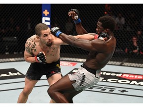 Robert Whittaker punches Jared Cannonier in their middleweight bout during UFC 254 on October 25, 2020 on UFC Fight Island, Abu Dhabi, United Arab Emirates.