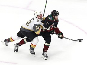 EDMONTON, ALBERTA - JULY 30: Nate Schmidt #88 of the Vegas Golden Knights hits Taylor Hall #91 of the Arizona Coyotes in the first period during an exhibition game prior to the 2020 NHL Stanley Cup Playoffs at Rogers Place on July 30, 2020 in Edmonton, Alberta.