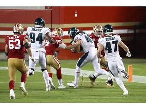 Alex Singleton, of the Philadelphia Eagles, runs with the ball after an interception on his way to scoring a touchdown in the fourth quarter against the San Francisco 49ers at Levi's Stadium on Sunday night in Santa Clara, Calif.