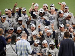 Members of the Tampa Bay Rays pose with the William Harridge Trophy after defeating the Houston Astros in Game 7 of the American League Championship Series at PETCO Park on October 17, 2020 in San Diego.