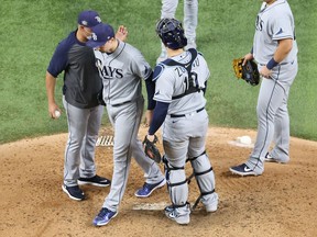 Tampa Bay Rays' pitcher Blake Snell stands between Los Angeles