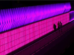 Calgary's night lights are shining brighter than ever before. Here, the 4th Street Illumination project changes colours as pedestrians move through the underpass. DARREN MAKOWICHUK/Postmedia