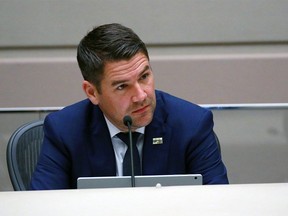 Councillor Evan Woolley listens as Calgary Police Chief Mark Neufeld answers questions in Calgary City Council Chambers on Thursday, September 10, 2020.