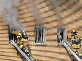 Calgary firefighters deal with a fire in a six-unit apartment building in the 100 block of 27th Avenue N.W. on Sunday, October 25, 2020.