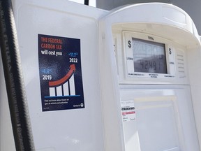 A gas pump displays an anti-carbon tax sticker in Toronto on Thursday, August 29, 2019.