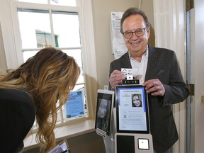 Statesman director Garth Mann and Sales and Events Director, Charlene Delisle officially opened its new event centre, Inn on Officers' Garden in the community of Currie as visitors to The Inn are greeted by a machine — a computer, with a body of sorts, called Dr. Wellness which provides an initial COVID screening test, in accordance with Alberta Health Services guidelines to help fight the novel coronavirus in Calgary on Thursday, October 15, 2020.