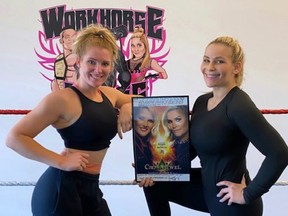 One year later, Lacey Evans and I pose with a picture from the first women’s match in Saudi Arabia.