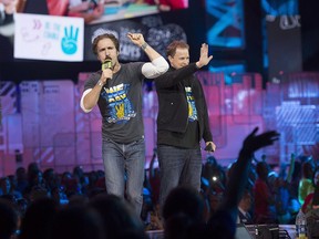 Craig Kielburger and Marc Kielburger speak during "We Day" in Toronto on Thursday, Oct. 2, 2014.