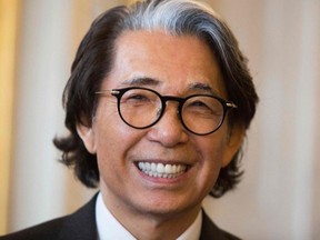 This file photo taken June 2, 2016 shows Japanese fashion designer Kenzo Takada smiling after being awarded Chevalier de la Legion d'Honneur (Knight of the Legion of Honour) by President of the French Constitutional Council, in Paris.