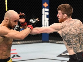 In this handout image provided by UFC, Cory Sandhagen punches Marlon Moraes of Brazil in their bantamweight bout during the UFC Fight Night event inside Flash Forum on UFC Fight Island on Saturday night in Yas Island, Abu Dhabi, United Arab Emirates. Photo by Josh Hedges/Zuffa LLC via Getty Images