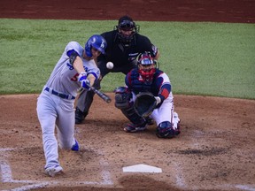 Los Angeles Dodgers shortstop Corey Seager hits a home run against the Atlanta Braves during Game 3 of the NLCS at Globe Life Field in Arlington, Texas, on Oct. 14, 2020.