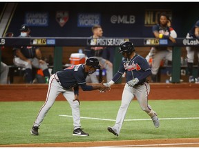 Oct 13, 2020; Arlington, Texas, USA; Atlanta Braves second baseman Ozzie Albies (1) is congratulated by third base coach Ron Washington (37) after hitting a solo home run during the ninth inning against the Los Angeles Dodgers in game two of the 2020 NLCS at Globe Life Field. Mandatory Credit: Tim Heitman-USA TODAY Sports ORG XMIT: IMAGN-431069