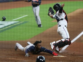 Atlanta Braves second baseman Ozzie Albies scores against Miami Marlins catcher Jorge Alfaro during Game 3 of the 2020 NLDS at Minute Maid Park in Houston on Oct. 8, 2020. Thomas Shea/USA TODAY Sports
