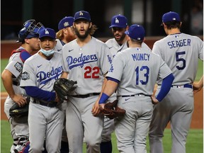 Oct 25, 2020; Arlington, Texas, USA; Los Angeles Dodgers manager Dave Roberts (30) takes starting pitcher Clayton Kershaw (22) out of the game during the sixth inning during game five of the 2020 World Series at Globe Life Field. Mandatory Credit: Kevin Jairaj-USA TODAY Sports ORG XMIT: IMAGN-431120