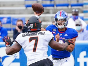 Kansas Jayhawks quarterback Miles Kendrick feels the heat of Oklahoma State Cowboys linebacker Amen Ogbongbemiga during the first half at David Booth Kansas Memorial Stadium. Jay Biggerstaff/USA TODAY Sports