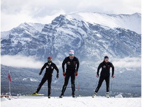 Olympians Dahria Beatty (R), Russell Kennedy (C) and legendary Paralympian, Brian McKeever, get back on snow for the first time in seven months thanks to the world-unique Frozen Thunder snow preservation project at the Canmore Nordic Centre, Monday, October 19, 2020. Photograph by Todd Korol