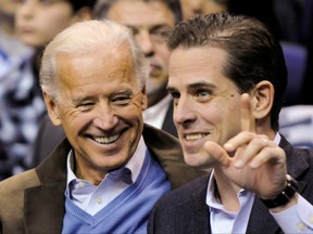 Joe Biden, left, and his son Hunter Biden attend an NCAA basketball game between Georgetown University and Duke University in Washington, U.S., January 30, 2010. (REUTERS/Jonathan Ernst)