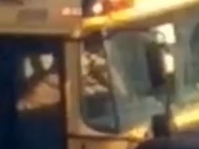 Still frame of a video capturing a Francobus school bus driver smoking in his bus
