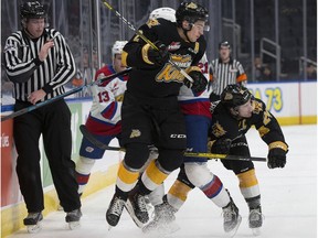 The Edmonton Oil Kings' Jake Neighbours (21) is checked by the Brandon Wheat Kings' Braden Schneider (2) and Connor Gutenberg (24) during third period WHL action at Rogers Place, in Edmonton Tuesday Jan. 28, 2020. The Oil Kings' won 6-2. Photo by David Bloom
