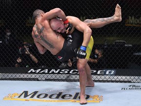 Glover Teixeira takes down Thiago Santos in a light-heavyweight fight during the UFC Fight Night event at UFC APEX in Las Vegas on Nov. 7, 2020.