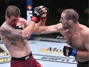 Sean Strickland punches Brendan Allen in a 195-pound catchweight fight during the UFC Fight Night event at UFC APEX on November 14, 2020 in Las Vegas, Nevada.