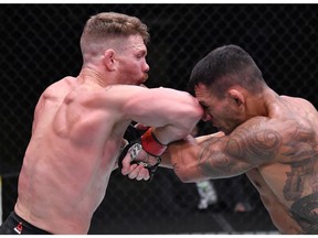 Paul Felder elbows Rafael Dos Anjos of Brazil in a lightweight fight during the UFC Fight Night event at UFC APEX on November 14, 2020 in Las Vegas, Nevada.