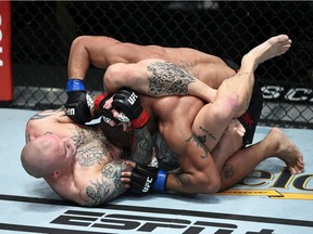 LAS VEGAS, NEVADA - NOVEMBER 28: In this handout image provided by the UFC, Anthony Smith (L) attempts to submit Devin Clark in their light heavyweight bout during the UFC Fight Night at UFC APEX on November 28, 2020 in Las Vegas, Nevada.