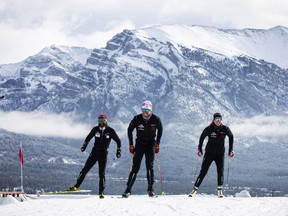 Olympians Dahria Beatty (R), Russell Kennedy (C) and legendary Paralympian, Brian McKeever, get back on snow for the first time in seven months thanks to the world-unique Frozen Thunder snow preservation project at the Canmore Nordic Centre, Monday, October 19, 2020. Photograph by Todd Korol