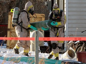 Emergency crews wearing HAZMAT suits are seen on a rural property east of Delacour as an ongoing RCMP investigation continues. Wednesday, November 25, 2020.