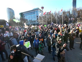 Hundreds of people gather to protest mandatory masks and other COVID-19 restrictions outside city hall in downtown Calgary on Nov. 28, 2020.