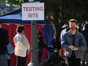People wait in line to get tested for COVID-19 in Los Angeles, California, Nov. 9, 2020.
