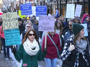 Hundreds of people protest mandatory masks at Calgary city hall on Saturday, Nov. 21, 2020.