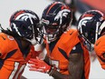DaeSean Hamilton, centre, of the Denver Broncos celebrates his touchdown with teammates Jerry Jeudy, left, and KJ Hamler as they take on the Los Angeles Chargers in the fourth quarter of the game at Empower Field At Mile High on Nov. 1, 2020 in Denver, Colorado.