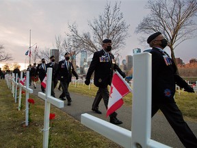 The honour guard marches after a sunrise remembrance ceremony at the Field of Crosses in Calgary on Thursday, November 5, 2020. The ceremony honoured media killed covering combat including Calgary Herald reporter Michelle Lang who was killed with four soldiers in a 2009 IED explosion in Afghanistan.