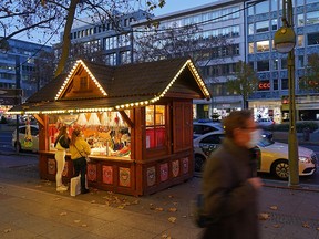 A man walks past a lone Christmas stall on Tauentzienstrasse during the second wave of the coronavirus pandemic on November 23, 2020 in Berlin.