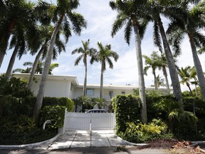 In this July 10, 2019 file photo, palm trees shade the Florida residence of Jeffrey Epstein in Palm Beach, Fla.