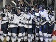 The Mount Royal Cougars celebrate during men's hockey action as the Mount Royal Cougars beat the University of Calgary Dino's 5-4 in double overtime in the 2020 Crowchild Classic at the Saddledome.  Thursday, January 30, 2020. Brendan Miller/Postmedia